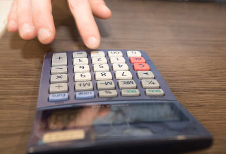 typing numbers in a pocket calculator with a LCD displayの写真素材