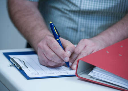 logging and taking notes in the administration and office workの写真素材