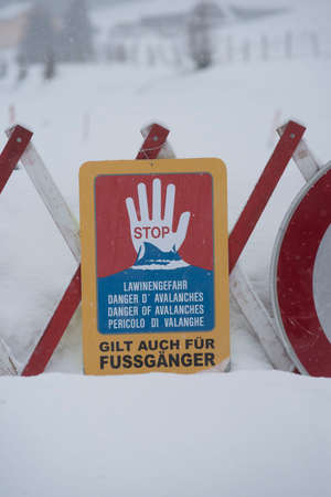 danger of avalanches warning sign in a snowy landscape in winter