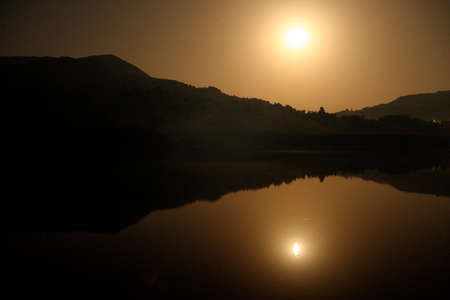 evening at the horizon sun at sunset, end of the dayの写真素材