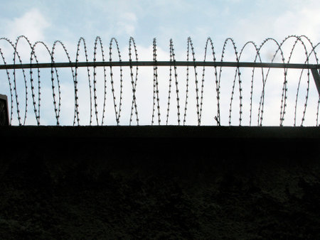 barbed wire as barrier in a prison, measure to prevent outbreaks