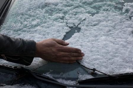 removing snow from the car, snow cleaning on a winter dayの写真素材