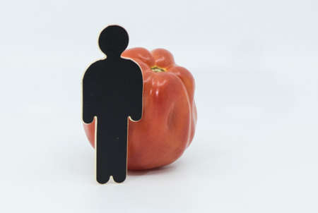 red and ripe tomato, healthy vegetable in a balanced dietの写真素材