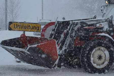 snow removal in the country, clearing streets and roads in winterの写真素材