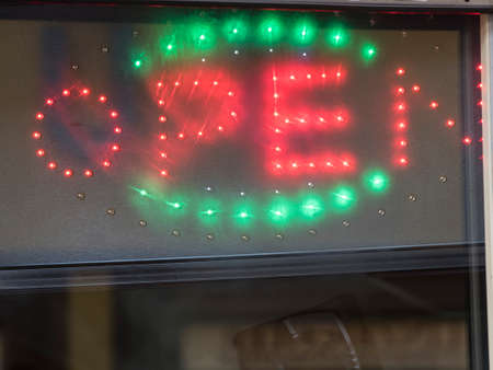 open sign and business hours at a company in trade and economy