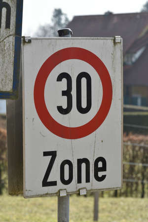 30 kilometers per hour speed limit sign on the street