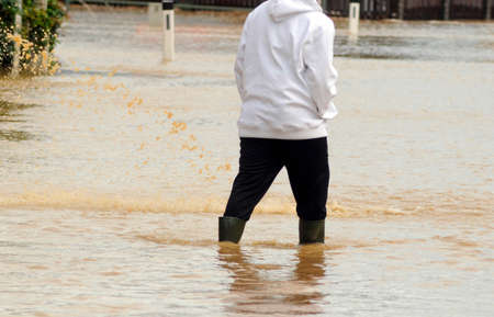 people after heavy rainfalls and thunderstorms took place at their homesの写真素材