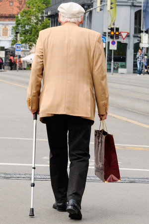 Senior man with a walking stick, walking aid for mobilityの写真素材