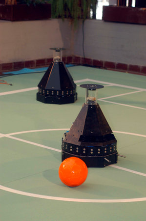 robots competing against each other on a field in a robotics competition