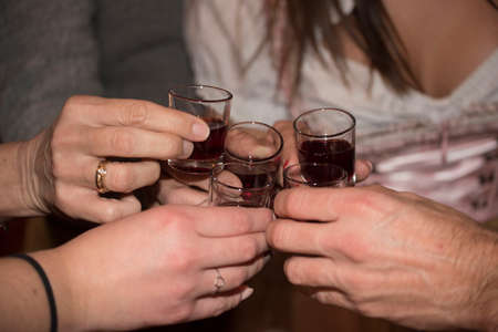 drinking a shot glass of schnapps or booze; hard liquor
