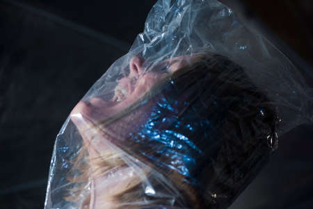 woman with bag over head symbolizing the feeling of claustrophobia
