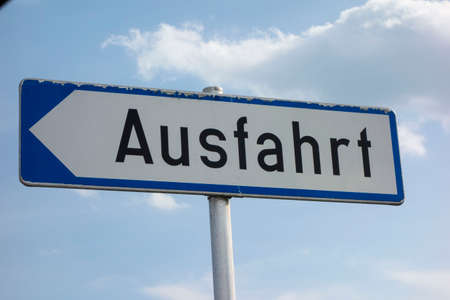 Direction sign with arrow showing the way in road trafficの写真素材