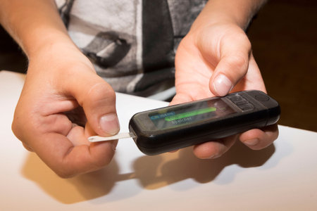measuring the blood sugar level with a blood glucose meterの写真素材