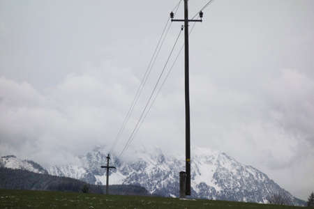 energy supply with a low voltage power line and power pole in winterの写真素材