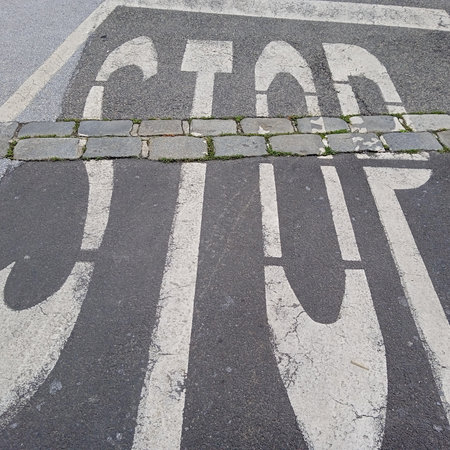 red stop sign in traffic, signaling the driver to completely stop