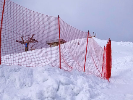 a closed ski slope in snowy landscape during winter holidaysの写真素材