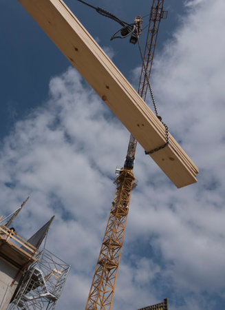 Construction crane with heavy load, at construction site