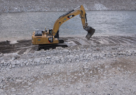an excavator from the Caterpillar brand in the construction worksのeditorial素材