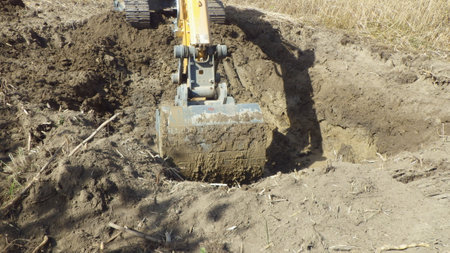 Earthworks with an excavator in civil engineering on a construction siteの写真素材