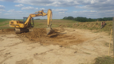 case excavator at a construction site, heavy machinery for earthworks and building projectのeditorial素材
