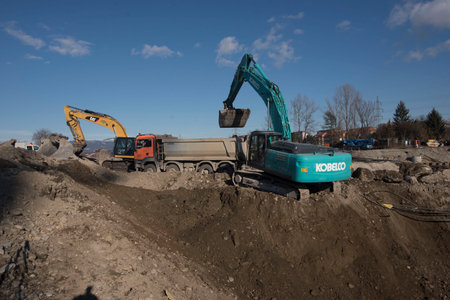 kobelco excavator at a construction site, heavy machinery for earthworks and building projectのeditorial素材