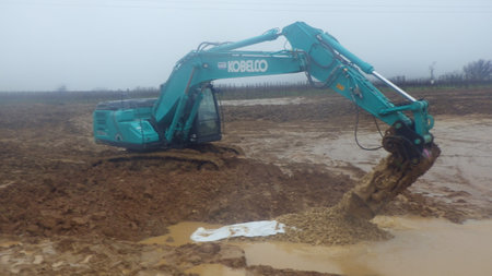 kobelco excavator at a construction site, heavy machinery for earthworks and building projectのeditorial素材