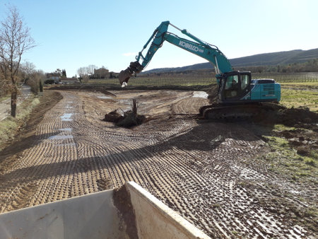 kobelco excavator at a construction site, heavy machinery for earthworks and building projectのeditorial素材