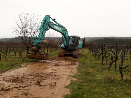 kobelco excavator at a construction site, heavy machinery for earthworks and building projectのeditorial素材
