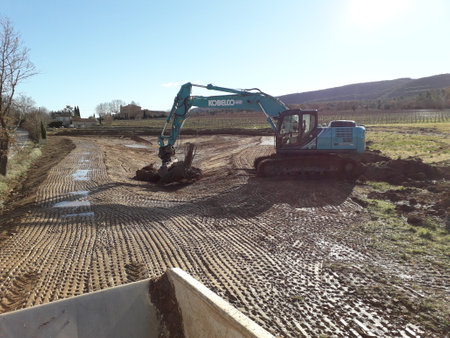 kobelco excavator at a construction site, heavy machinery for earthworks and building projectのeditorial素材