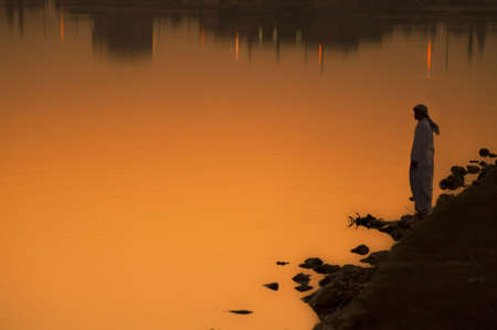 an standing on lake at sunsetの写真素材