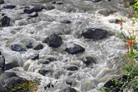 stones in the middle of the river whirlpoolの写真素材