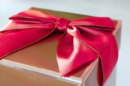 Golden present with red bowの写真素材
