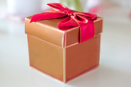 Golden present with red bowの写真素材