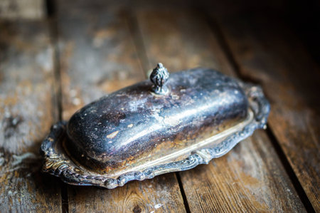 Vintage silver butter dish on wooden backgroundの写真素材