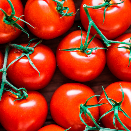 Tomatoes on wooden backgroundの写真素材