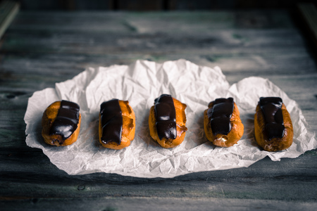 Eclairs on rustic background