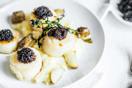 Scallops with black caviarの写真素材
