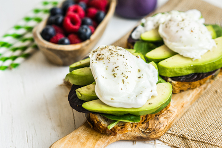 Healthy sandwich with avocado and poached eggsの写真素材