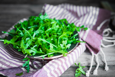 Arugula salad on wooden backgroundの写真素材