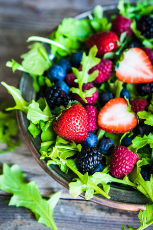 Green salad with arugula and berriesの写真素材