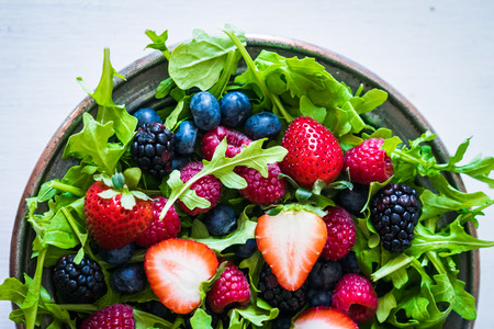 Green salad with arugula and berriesの写真素材