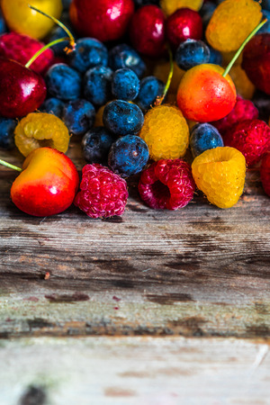 Mix of berries on wooden backgroundの写真素材