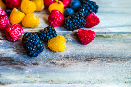 Mix of berries on wooden background