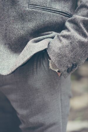 Closeup of broom's hand in the pocketの写真素材