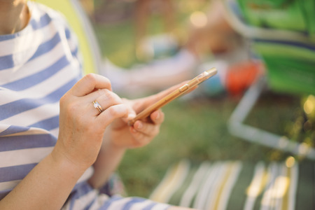 Woman is sending text messages on her smartphoneの写真素材