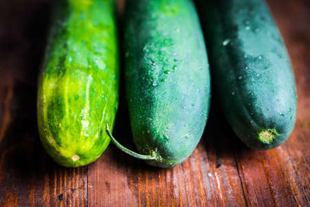 Cucumbers on wooden backgroundの写真素材