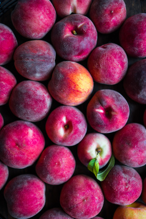 Fresh picked peaches on wooden backgroundの写真素材