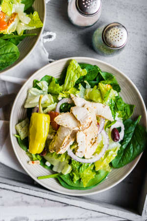 Green chicken salad on wooden backgroundの写真素材