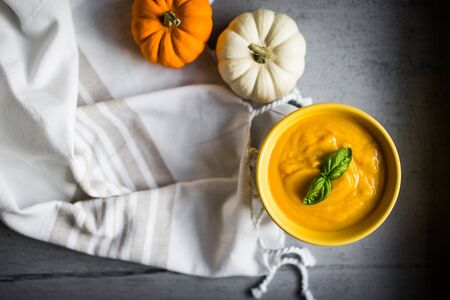 Pumpkin soup on rustic backgroundの写真素材