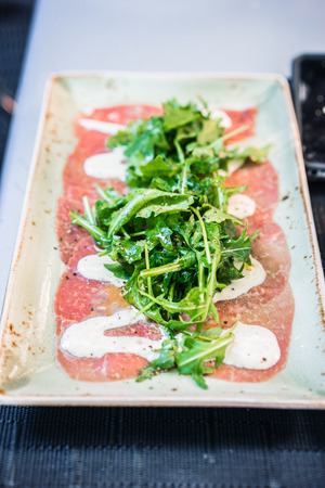 Beef carpaccio with arugulaの写真素材